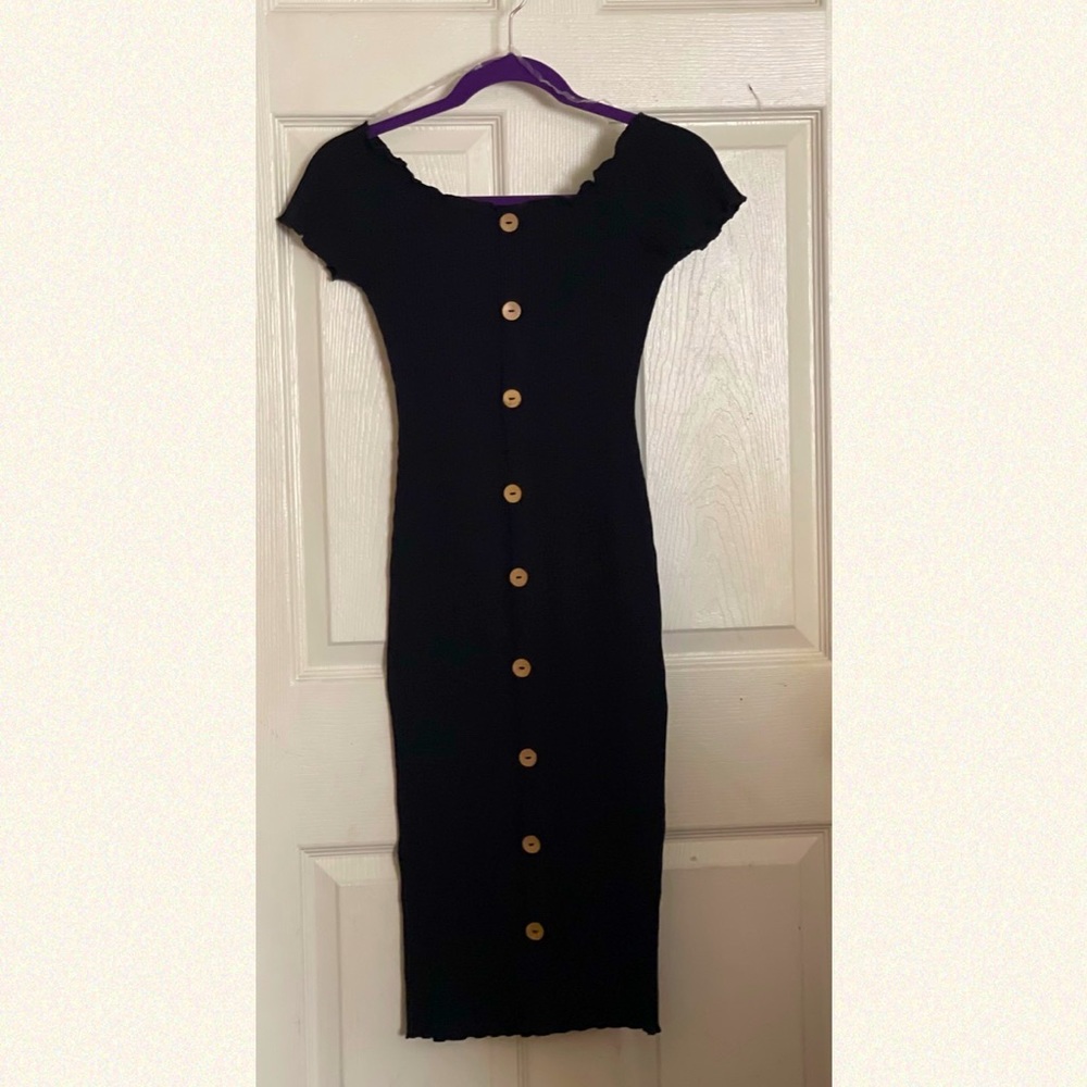 A black, off the shoulder, Derek Heart bodycon dress with tan buttons.